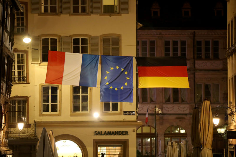 © Reuters. French, German and European Union flags fly over a street of Strasbourg during a military ceremony as part of the celebrations to mark the 100th anniversary of the end of World War One in Strasbourg