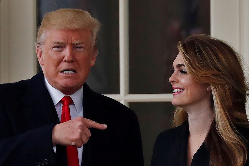 © Reuters. FILE PHOTO: U.S. President Trump reacts as he stands next to former White House Communications Director Hope Hicks outside of the Oval Office as he departs for a trip to Cleveland, Ohio, in Washington D.C.