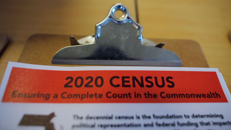 © Reuters. An informational pamphlet is displayed at an event for community activists and local government leaders to mark the one-year-out launch of the 2020 Census efforts in Boston