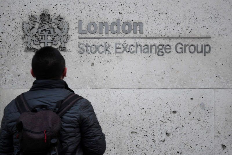 © Reuters. People walk past the London Stock Exchange Group offices in the City of London, Britain