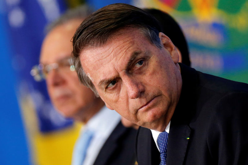 © Reuters. Brazil's President Jair Bolsonaro looks on during a ceremony of the Brazilian National Development Bank (BNDES) Line of Credit for Philanthropic Organizations at the Planalto Palace in Brasilia
