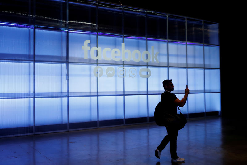© Reuters. FILE PHOTO: An attendee takes a photograph of a sign during Facebook Inc's F8 developers conference in San Jose