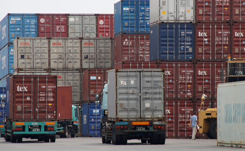 © Reuters. A laborer works in a container area at a port in Tokyo