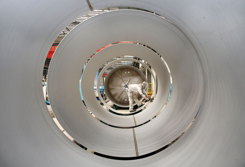 © Reuters. FILE PHOTO: Employee works on the production line of tanks for liquefied natural gas (LNG) at an energy equipment company in Nantong