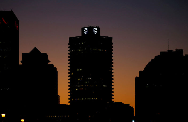 © Reuters. FILE PHOTO: The logo of South Africa's Standard Bank is seen above the company's headquarters in Cape Town