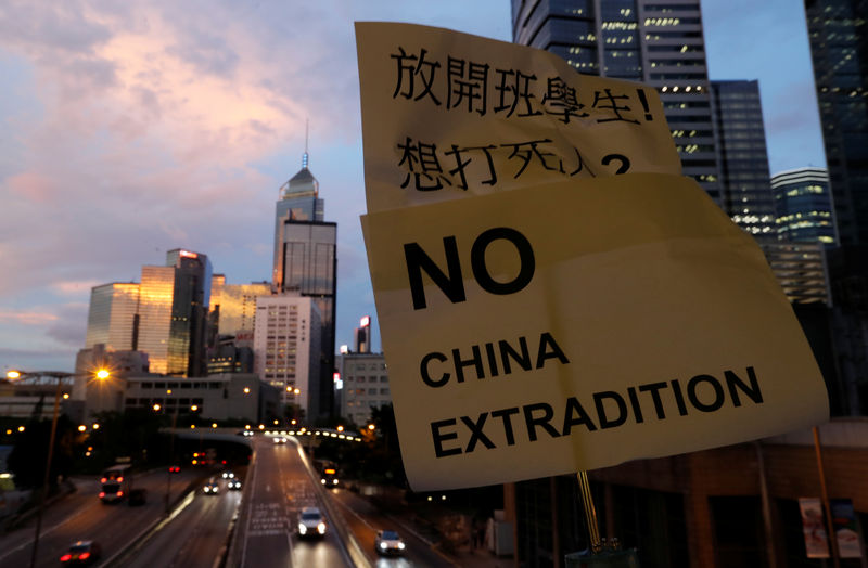 © Reuters. A placard is displayed during a protest following a day of violence over a proposed extradition bill, near the Legislative Council building in Hong Kong