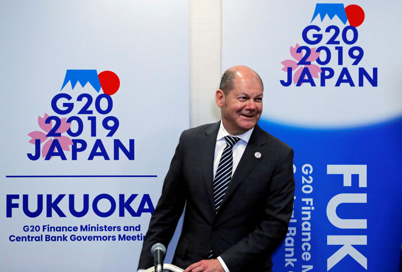 © Reuters. FILE PHOTO: German Finance Minister Olaf Scholz attends a news conference during the G20 Finance Ministers and Central Bank Governors Meeting in Fukuoka