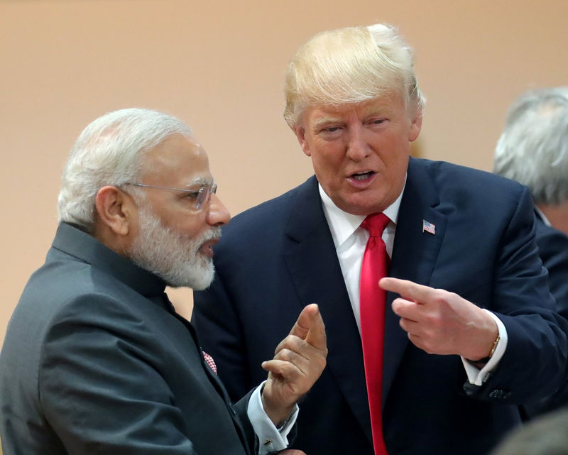 © Reuters. FILE PHOTO: U.S. President Donald Trump chats with India's Prime Minister Narendra Modi during a working session at the G20 leaders summit in Hamburg,