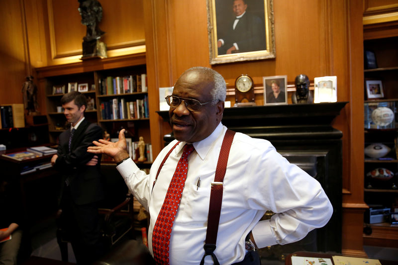 © Reuters. FILE PHOTO: U.S. Supreme Court Justice Thomas talks in his chambers at the U.S. Supreme Court building in Washington