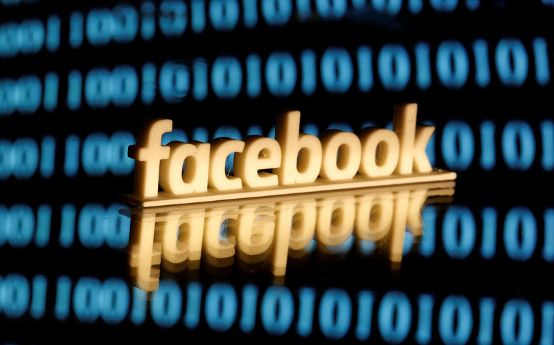 © Reuters. Facebook logo is seen in front of displayed binary code in this illustration picture
