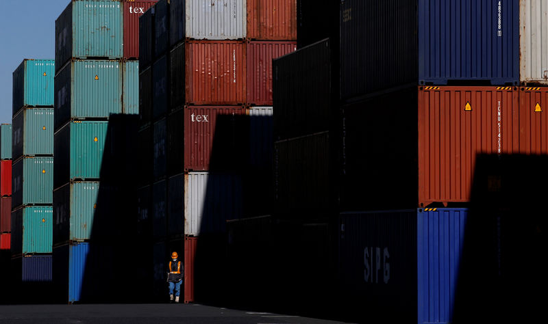 © Reuters. FILE PHOTO: Worker walks in a container area at a port in Tokyo