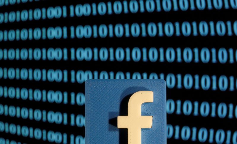 © Reuters. A 3-D printed Facebook logo is seen in front of displayed binary code in this illustration picture