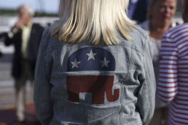 © Reuters. FILE PHOTO - A Republican supporter wears a party logo on her denim jacket before a sunset cruise with the Belknap County Republicans in Laconia