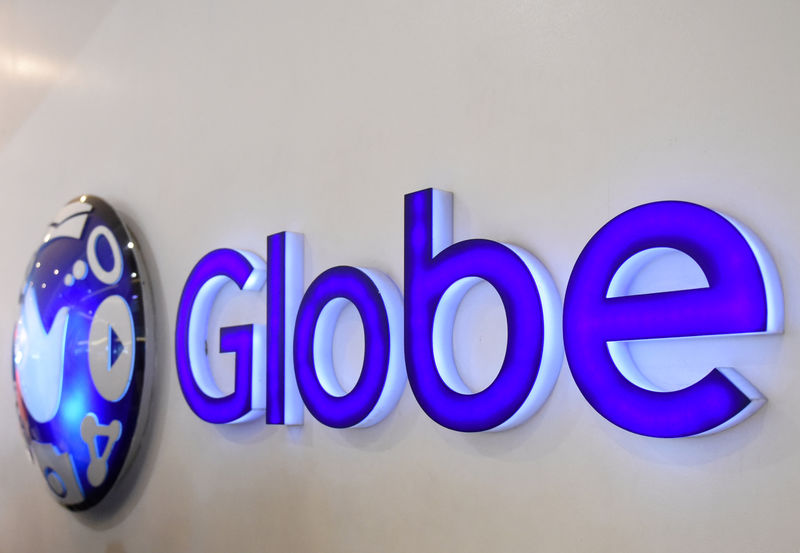 © Reuters. FILE PHOTO: A logo of Globe Telecom is seen at a Globe service center in Edsa, Quezon City, metro Manila