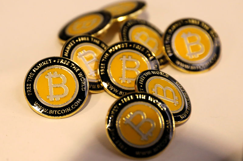 © Reuters. FILE PHOTO: Bitcoin.com buttons are seen displayed on the floor of the Consensus 2018 blockchain technology conference in New York City