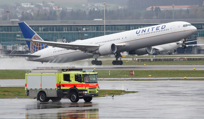 © Reuters. FILE PHOTO: A vehicle of the airport rescue and firefighting services stands in front as a Boeing 767 aircraft of United Airlines takes off from Zurich airport