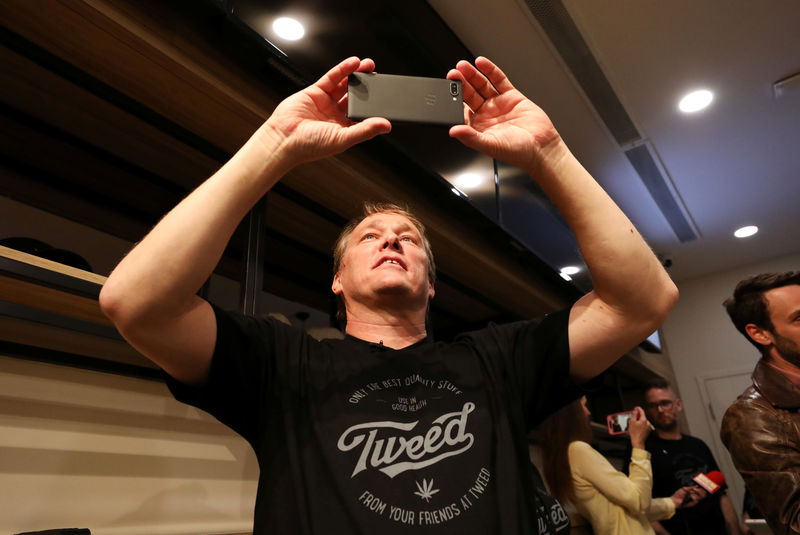 © Reuters. FILE PHOTO: Canopy Growth CEO Bruce Linton takes photos ahead of the first legal recreational marijuana sale at a Tweed retail store in St John's