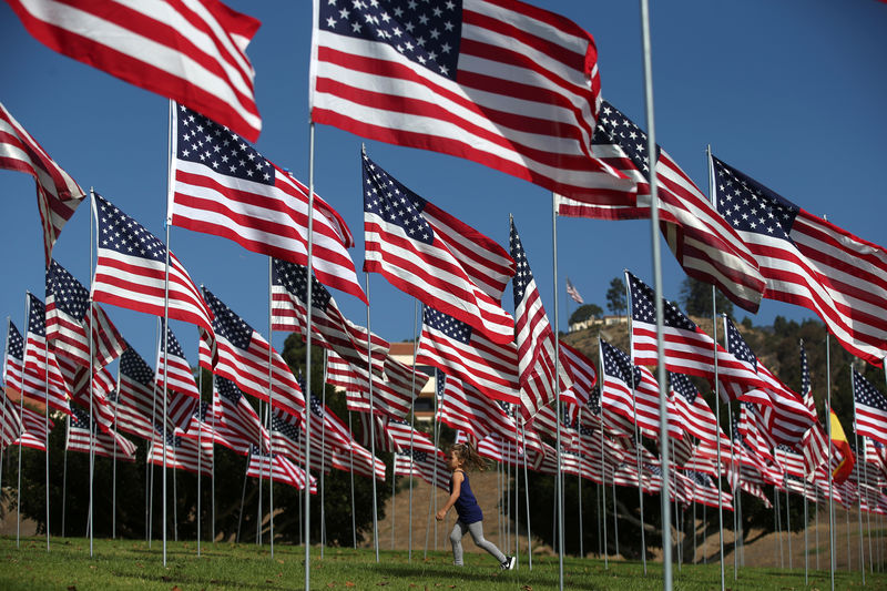 © Reuters. A girl walks through a memorial for the victims of the Sept. 11, 2001 attacks on the 15th anniversary, in Malibu