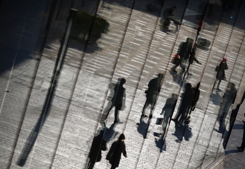 © Reuters. FILE PHOTO: Shoppers are reflected in the window of a retail store in the Taikoo Li Sanlitun fashionable shopping area in Beijing