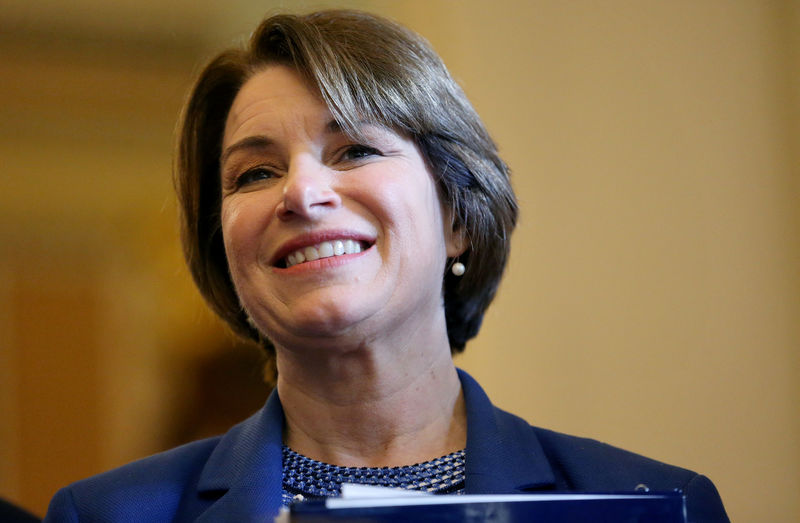 © Reuters. FILE PHOTO: U.S. Sen. Amy Klobuchar listens as Democratic Leader Schumer speaks to the media on Capitol Hill in Washington