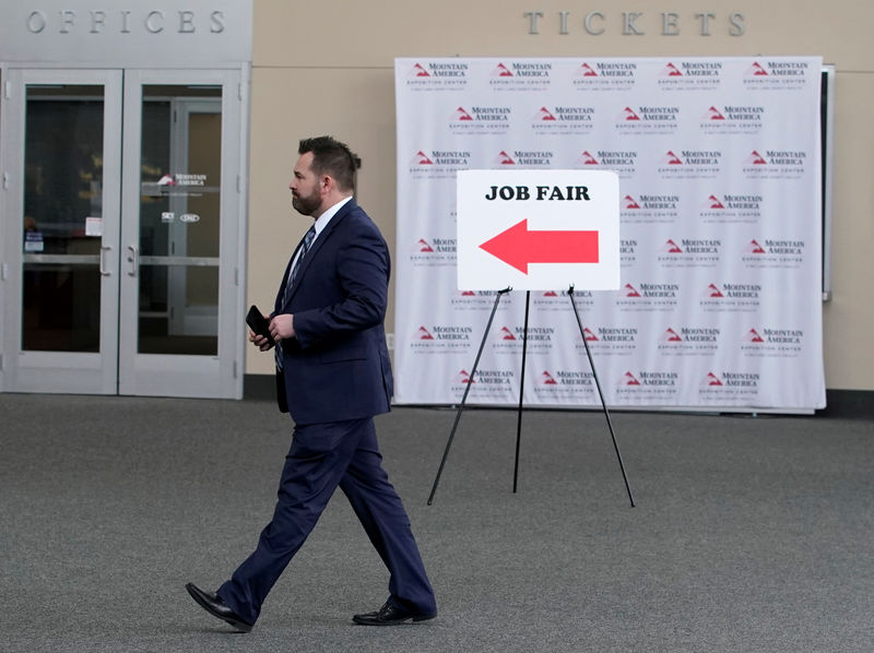 © Reuters. FILE PHOTO: A man walks into register at a job fair in Sandy, Utah