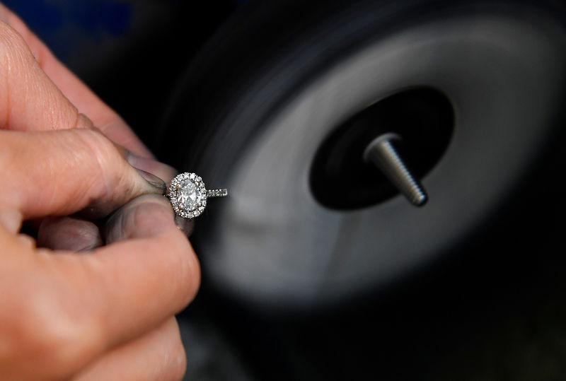 © Reuters. A specialist craftsperson polishes a diamond ring at the jewellery workshop of 77 Diamonds in London