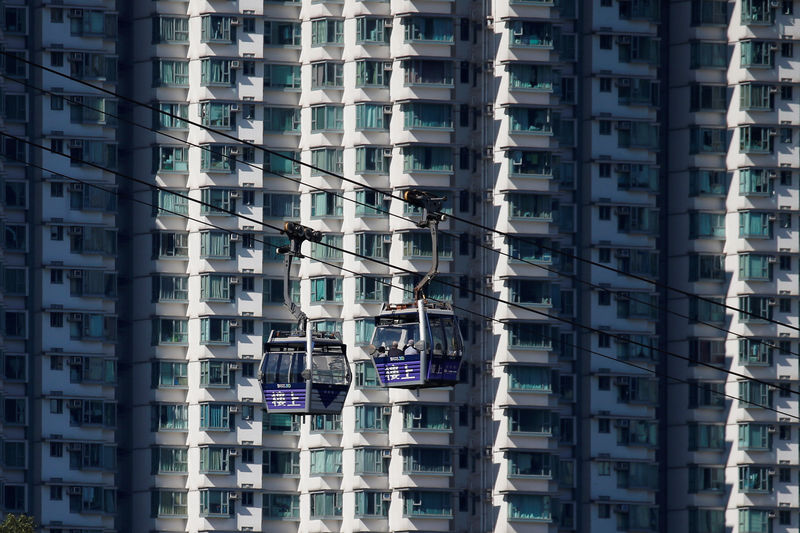 © Reuters. Cable cars move past residential flats at Lantau island in Hong Kong