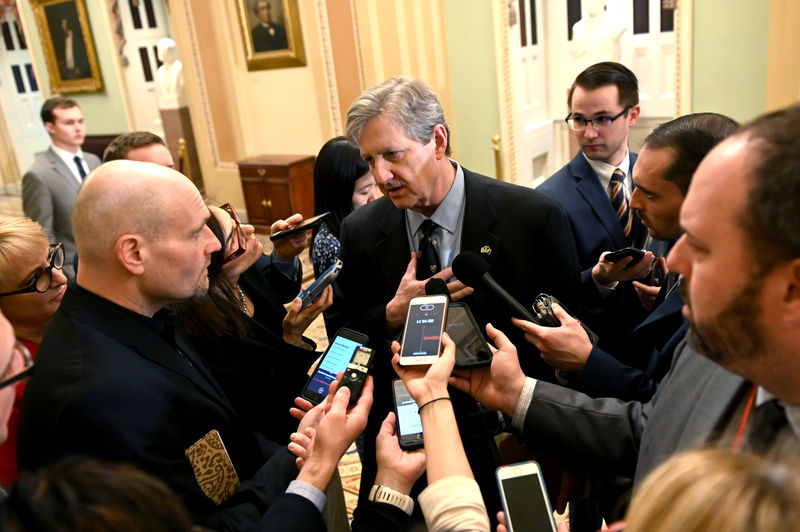 © Reuters. FILE PHOTO: Senator Kennedy speaks with the press