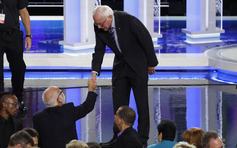 © Reuters. Senator Bernie Sanders shakes hands with a man in the crowd after the second night of the first U.S. 2020 presidential election Democratic candidates debate in Miami, Florida, U.S.