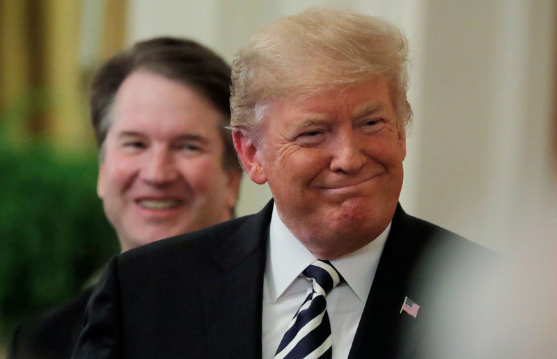 © Reuters. FILE PHOTO: U.S. President Donald Trump smiles next to U.S. Supreme Court Associate Justice Brett Kavanaugh as they participate in a ceremonial public swearing-in in the East Room of the White House in Washington