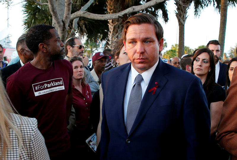 © Reuters. FILE PHOTO: Florida Republican Gov. Ron DeSantis (R) arrives at a memorial service on the one-year anniversary of the shooting which claimed 17 lives at Marjory Stoneman Douglas High School in Parkland