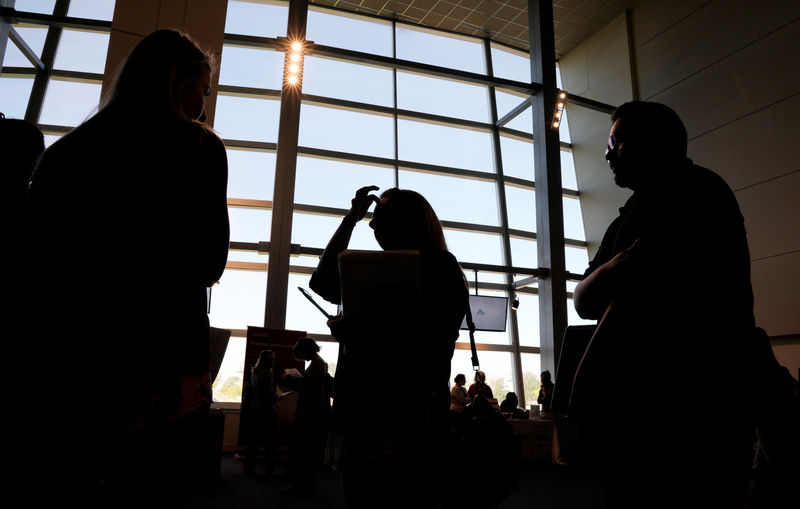 © Reuters. FILE PHOTO: A job seeker talks to a recruiter at a job fair in Denver