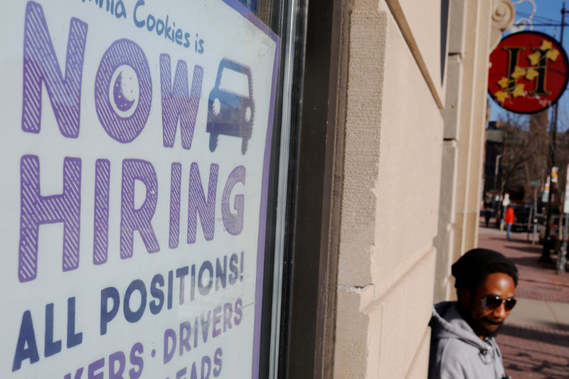 © Reuters. FILE PHOTO: A "Now Hiring" sign sits in the window of Insomnia Cookies in Cambridge