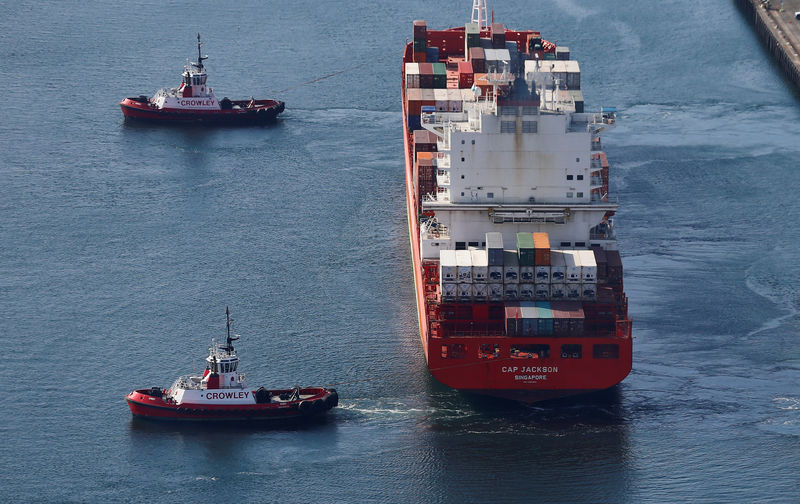 © Reuters. FILE PHOTO: An aerial photo shows the Cap Jackson container ship, registered in Singapore, as it is escorted by tugboats at Harbor Island at the Port of Seattle in Seattle