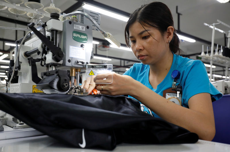 © Reuters. A woman works at Maxport garment company in Hanoi
