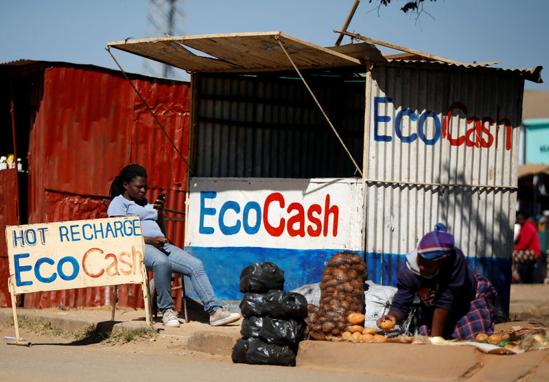 © Reuters. A street vendor awaits customers outside a stall at a marketplace in Chitungwiza