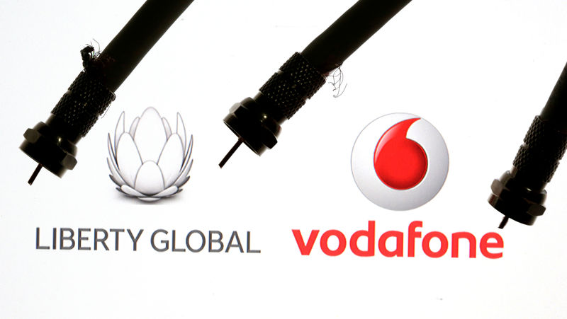 © Reuters. FILE PHOTO: Coaxial TV Cables are seen in front of Vodafone and Liberty Global logos in this illustration