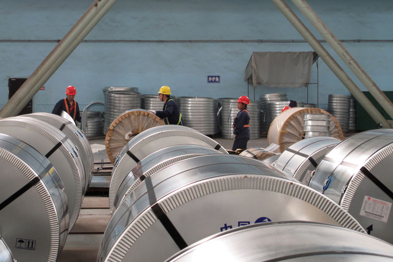 © Reuters. FILE PHOTO: Workers pack cold rolled steel coil at a steel company in Zhangjiagang