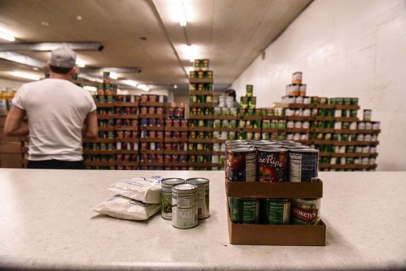 © Reuters. FILE PHOTO: A worker places packaged food onto a counter inside of a food distribution center on the Cheyenne River Indian Reservation in Eagle Butte, South Dakota