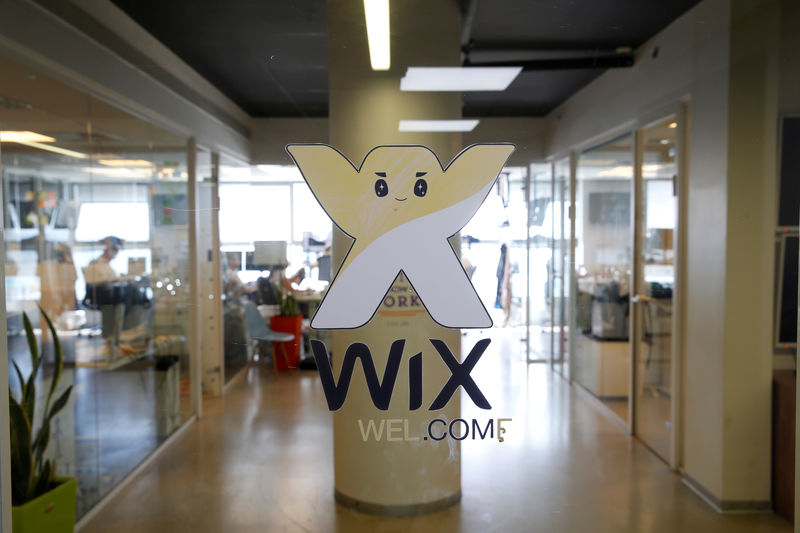 © Reuters. FILE PHOTO: Employees work at website-designer firm Wix.com offices in Tel Aviv