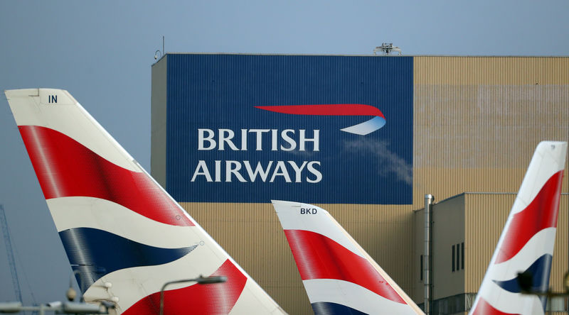 © Reuters. FILE PHOTO: British Airways logos on aircraft tail fins at Heathrow Airport