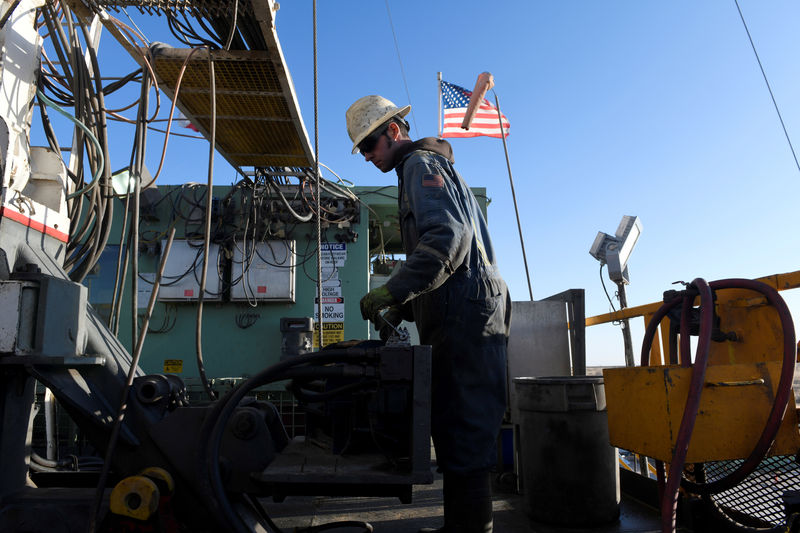 © Reuters. A worker operates equipment on a drilling rig near Midland