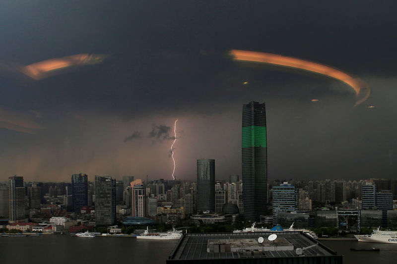 © Reuters. A streak of lightning is seen above the skyline of Shanghai