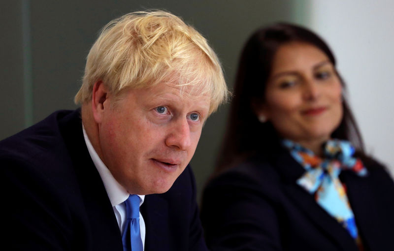 © Reuters. Britain's Prime Minister Johnson speaks alongside Home Secretary Patel during the first meeting of the National Policing Board at the Home Office in London