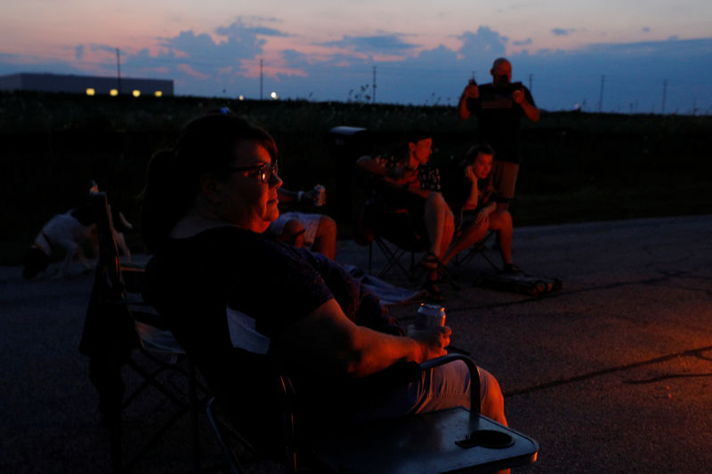 © Reuters. Jim and Kim Mahoney are joined by friends for a bonfire at their home in Mt. Pleasant