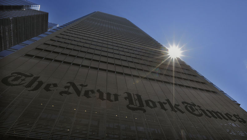 © Reuters. The sun peaks over the New York Times Building in New York