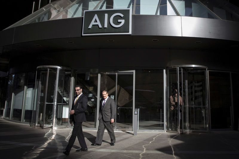 © Reuters. FILE PHOTO: People exit the AIG building in New York's financial district