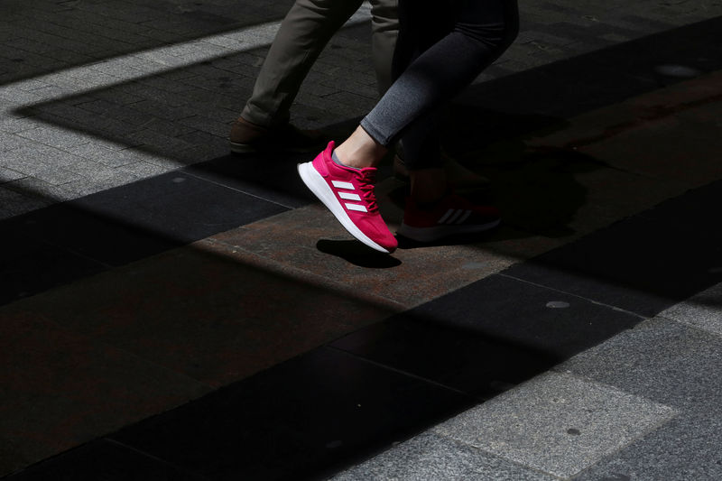 © Reuters. FILE PHOTO: A woman wears Adidas sports shoes in central Madrid