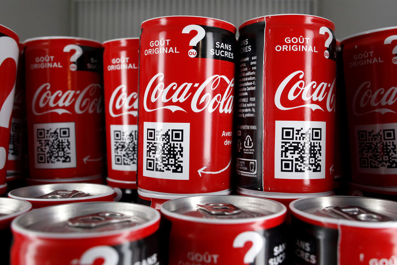 © Reuters. FILE PHOTO: Cans of Coca-Cola are pictured in a refrigerator during an event in Paris