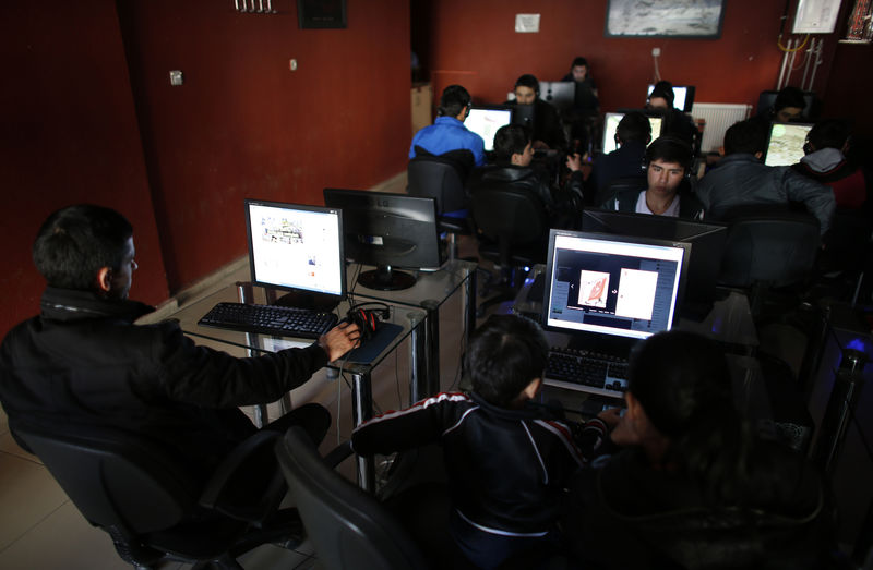 © Reuters. People use computers at an internet cafe in Ankara